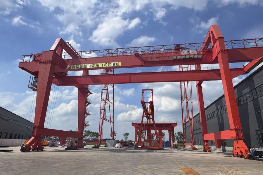 Full gantry crane assembling large ship sections in shipyard